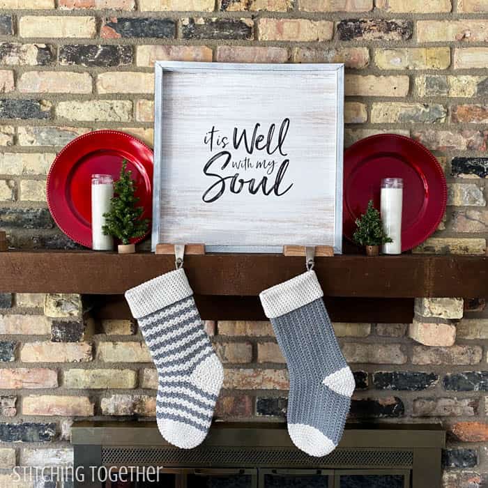 two Christmas stockings hanging from a mantle