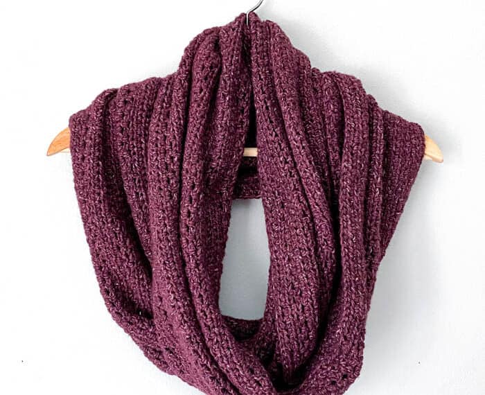 large burgundy infinity scarf wrapped on a hanger