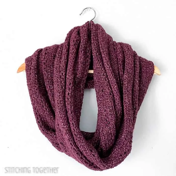 large burgundy infinity scarf wrapped on a hanger