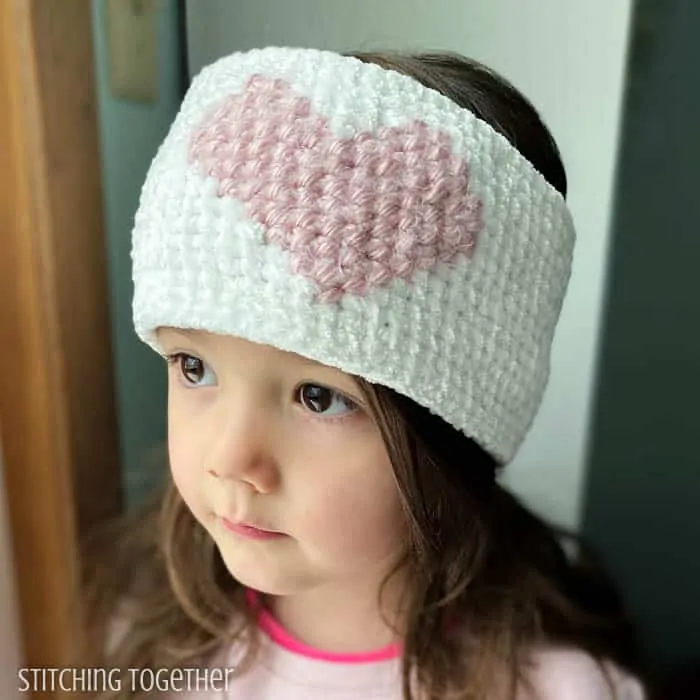 girl wearing crochet heart headband