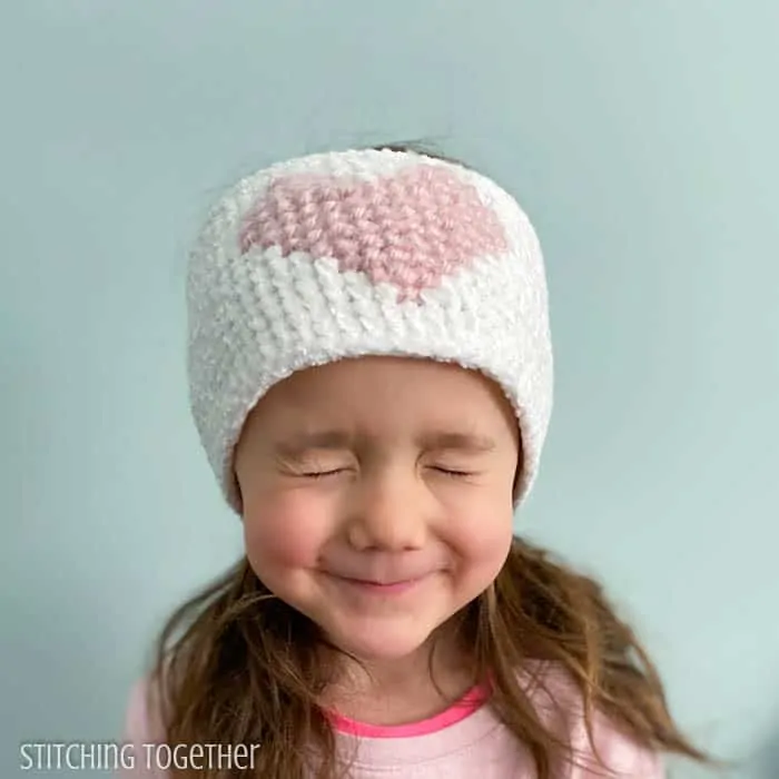 girl wearing heart crochet headband