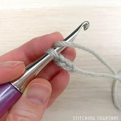 crochet hook with yarn showing steps in a stitch