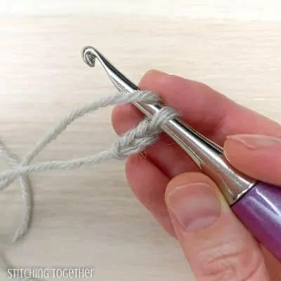 crochet hook with yarn and 2 chains