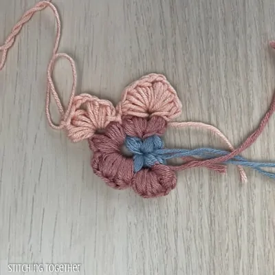 crocheting around adding more puff stitches to butterfly