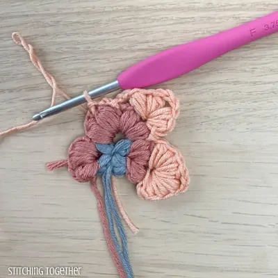 crocheting around adding more puff stitches to butterfly