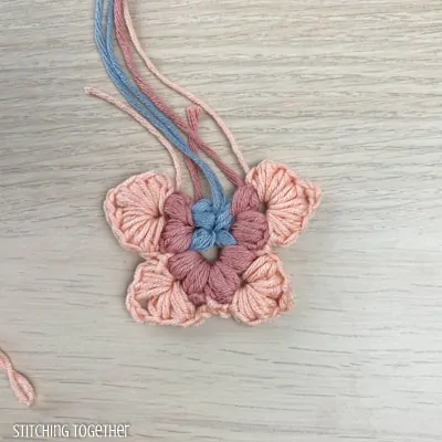 crocheting around adding more puff stitches to butterfly