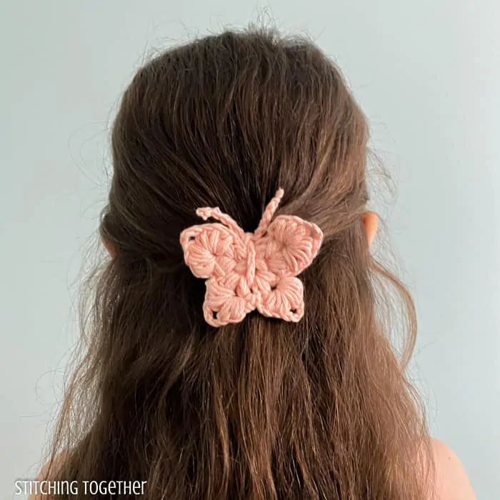girl with a crochet butterfly barrette in her hair