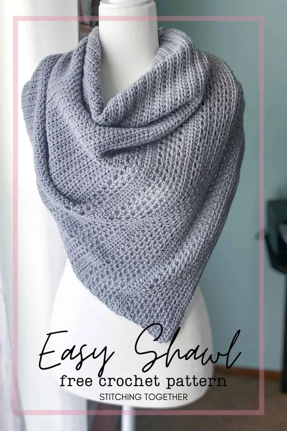 mannequin wearing gray crochet triangle shawl