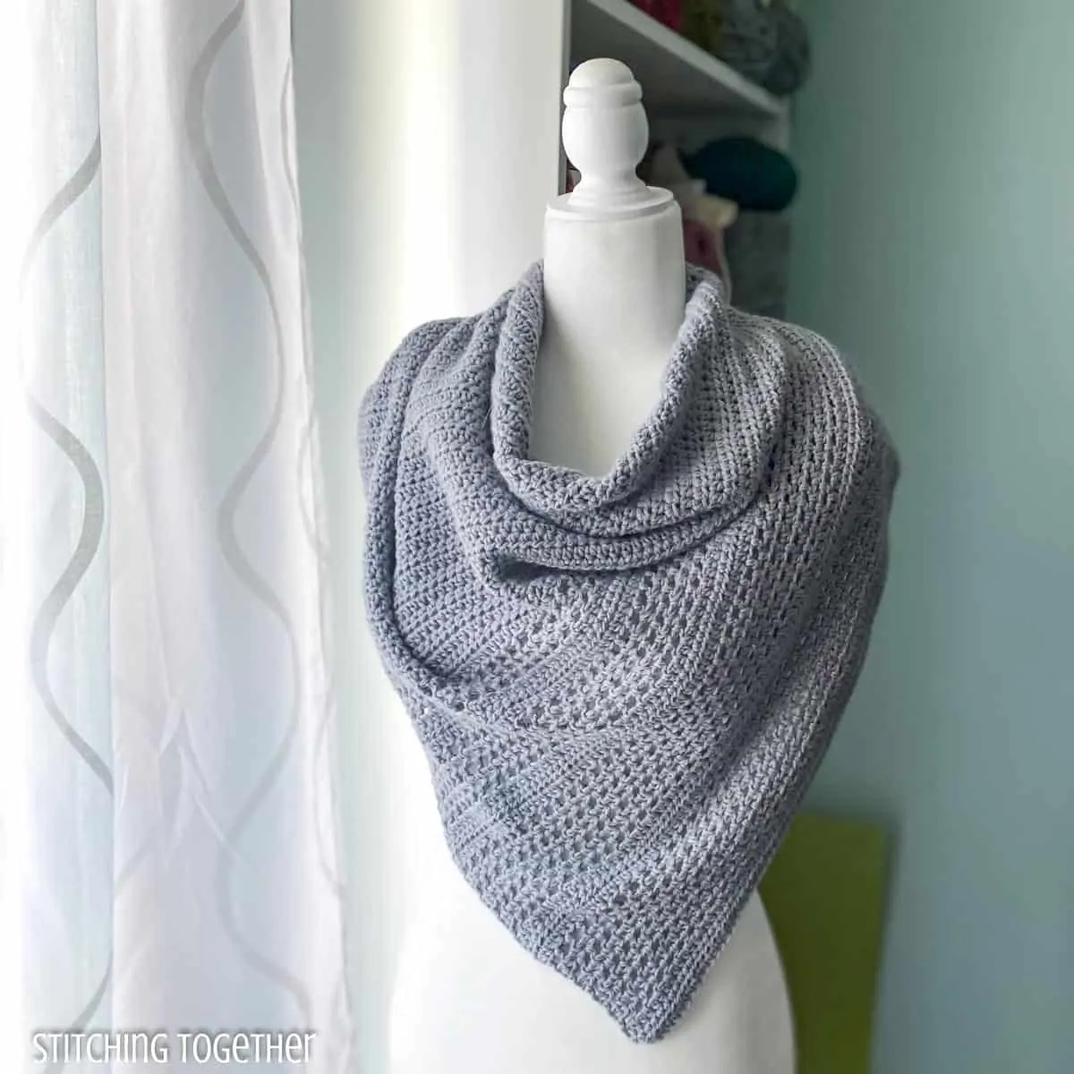 crochet shawl on a mannequin