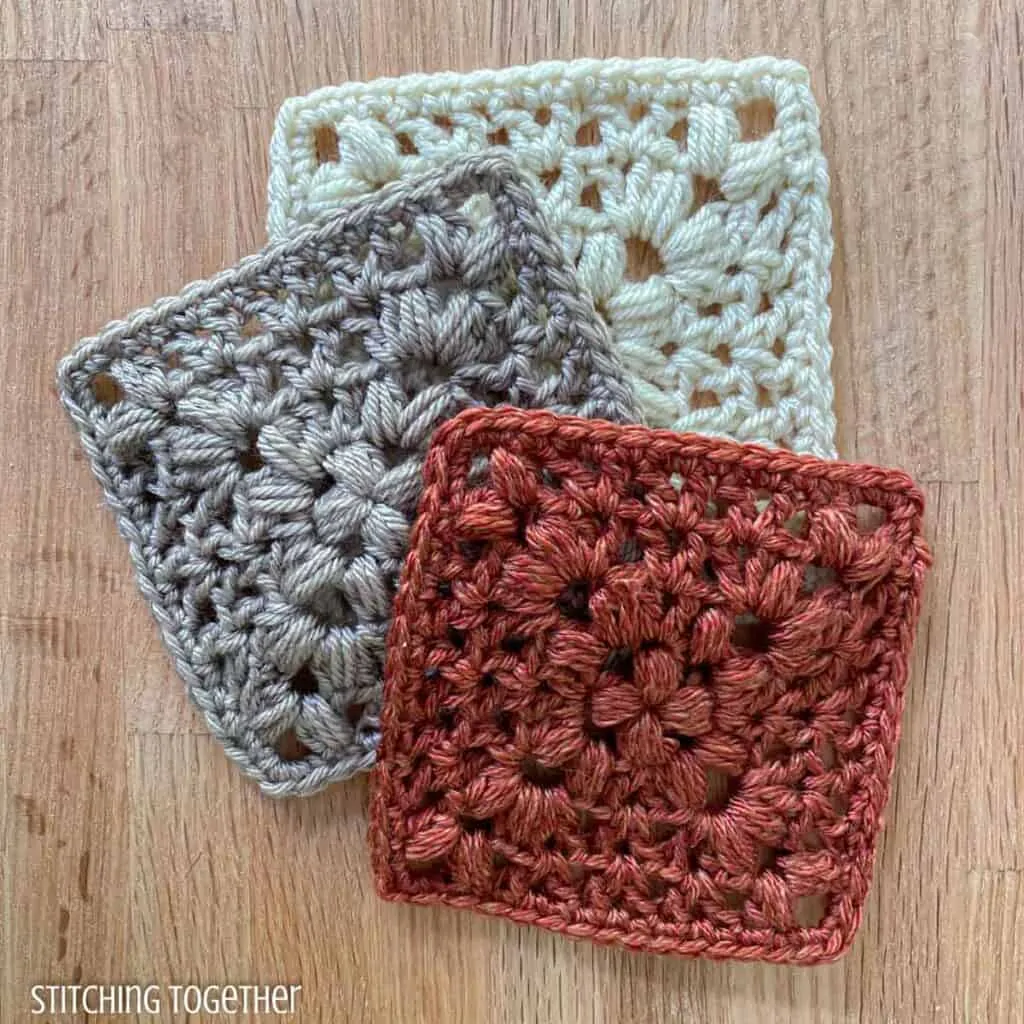 3 crochet granny squares messily stacked on top of each other