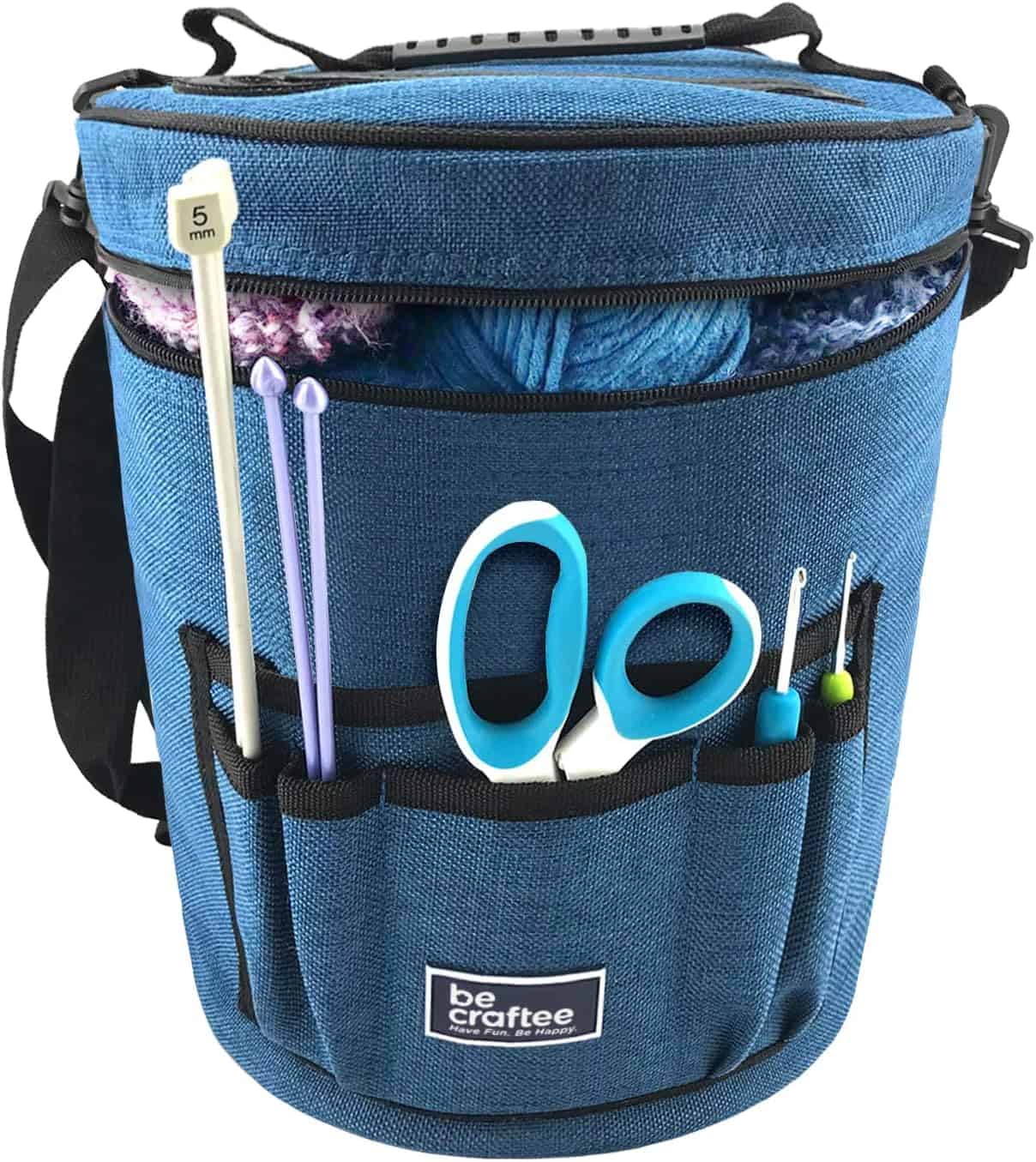 blue storage back with scissors and knitting needles sticking out the sides