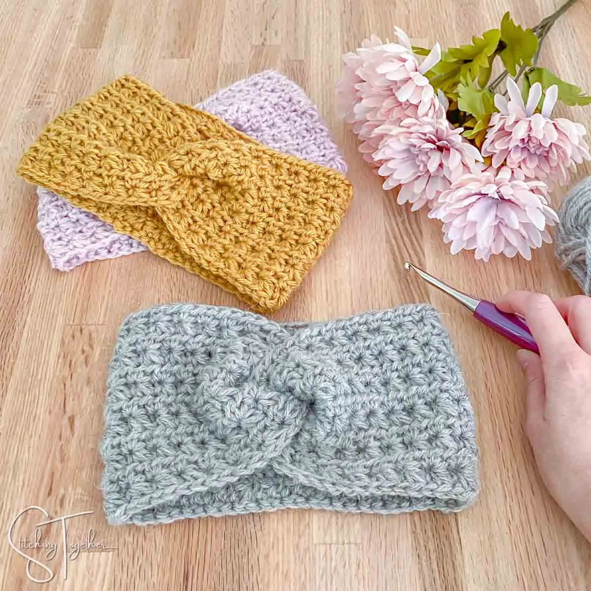 3 twist crochet headbands with a crochet hook and flowers