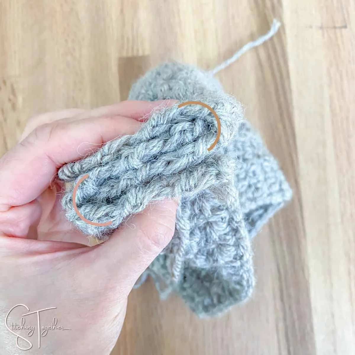 a crochet rectangle being folded together to make a headband