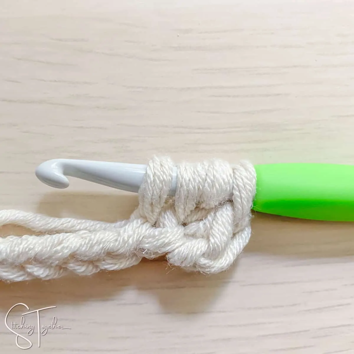 crochet hook and yarn showing the steps for a mhdc3tog