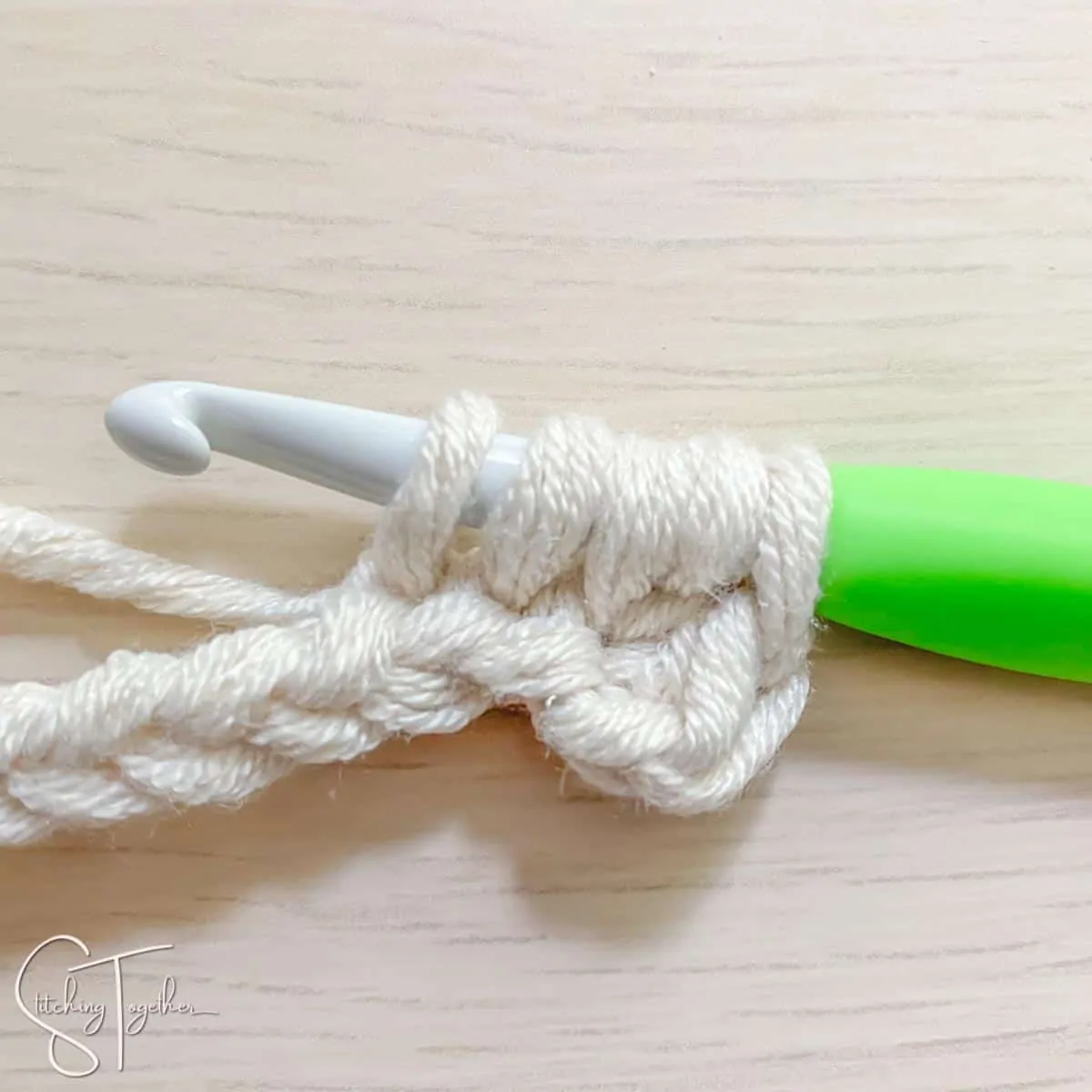 crochet hook and yarn showing the steps for a mhdc3tog