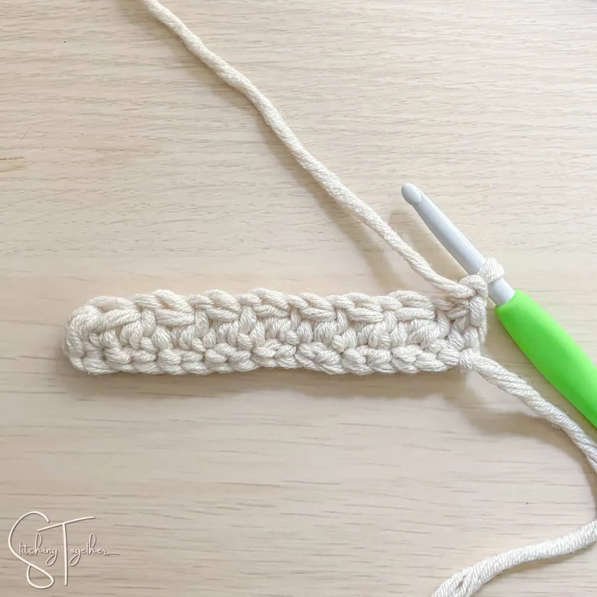 crochet hook and yarn showing the steps for a mhdc3tog