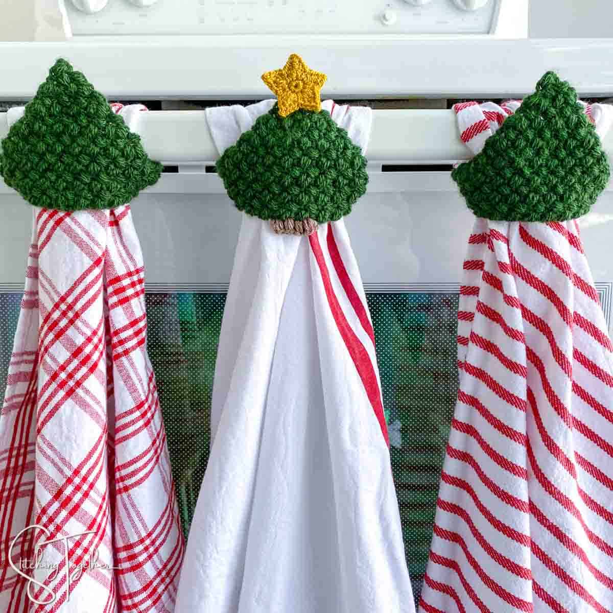 3 hanging Christmas dishtowels with crochet tree toppers