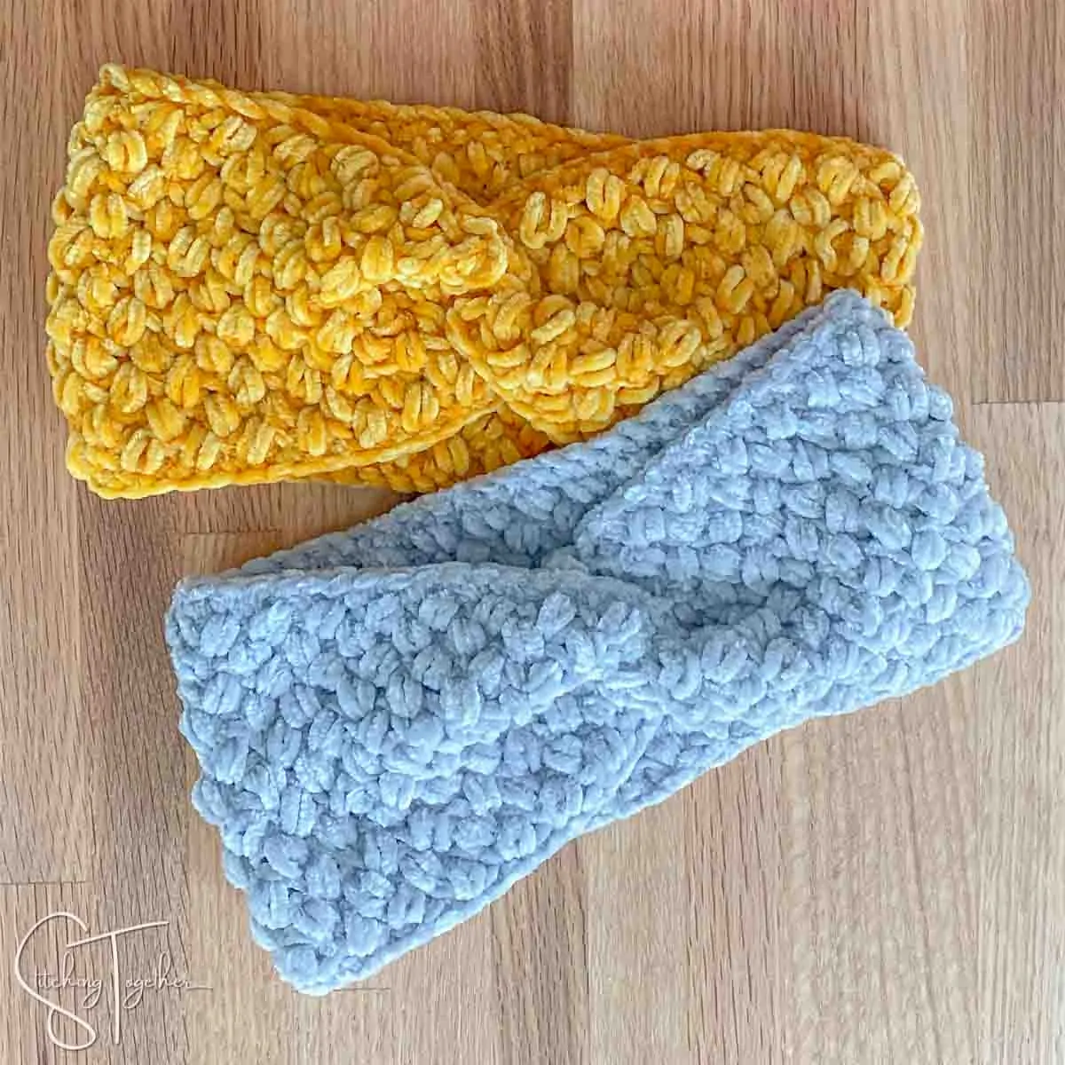 two crochet headbands with twists laying flat