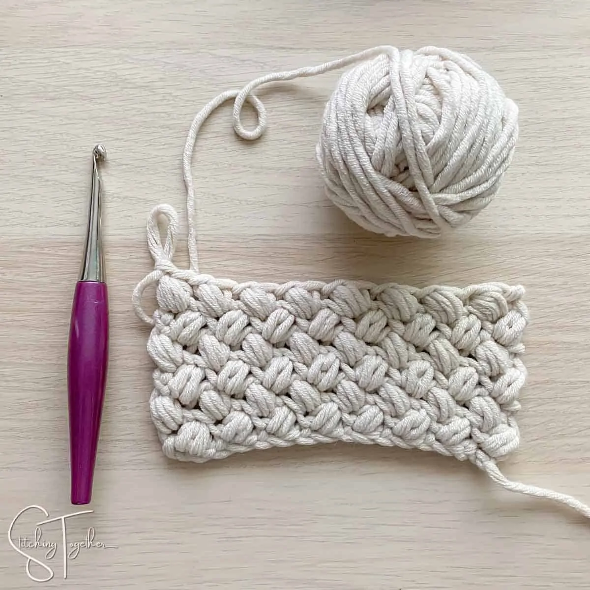 ball of yarn, hook, and bean stitch swatch
