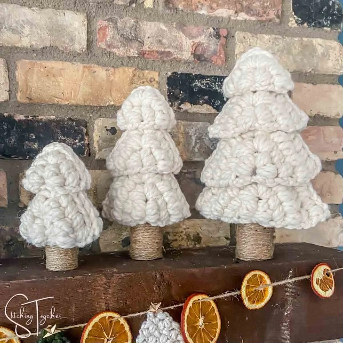 3 chunky crochet Christmas trees on a mantle