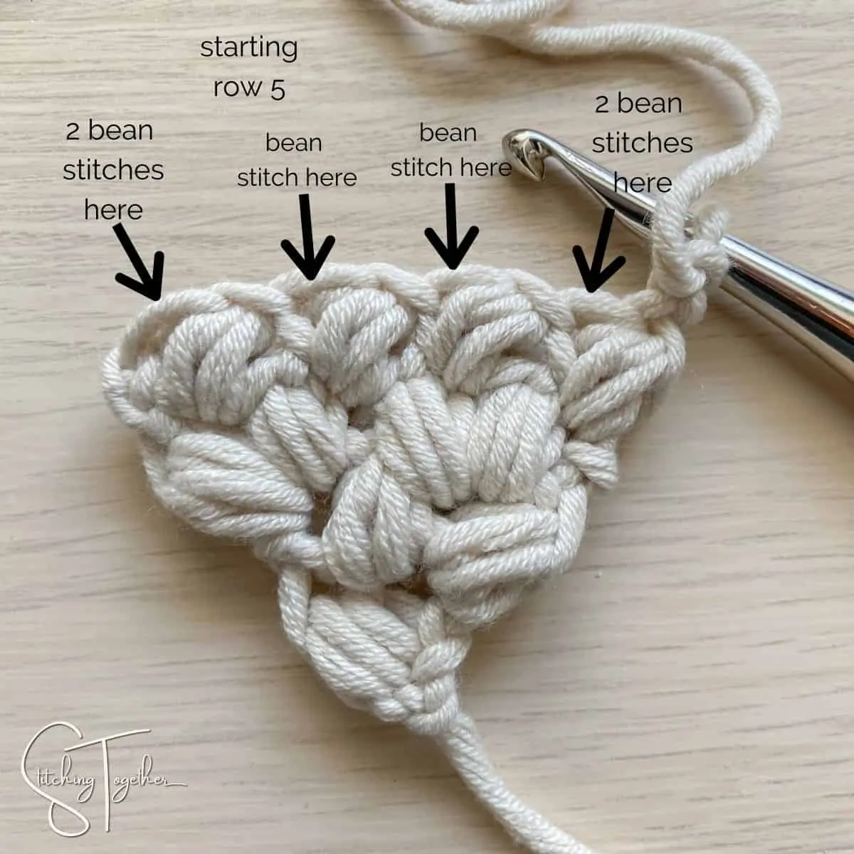 arrows showing where to place the stitches for row 5 on crochet fabric