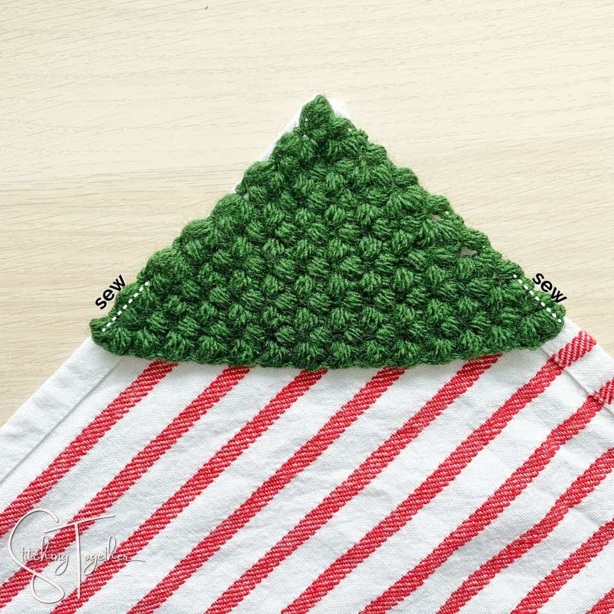 crochet christmas tree on a dishtowel with indications where to sew