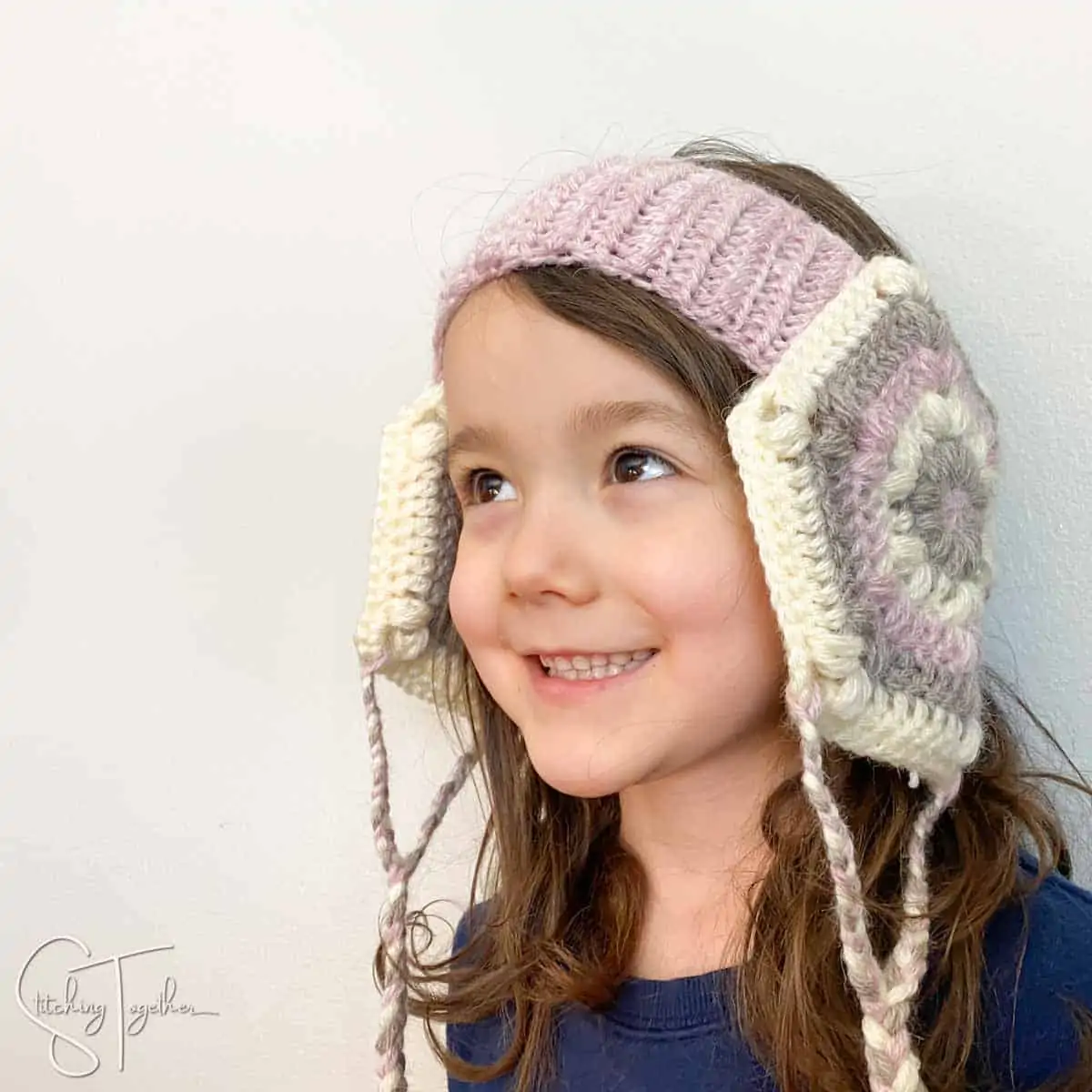 child wearing handmade crochet head warmer
