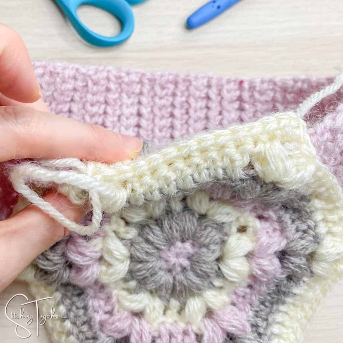 showing the single crochet row that secured the ear flaps to the headband