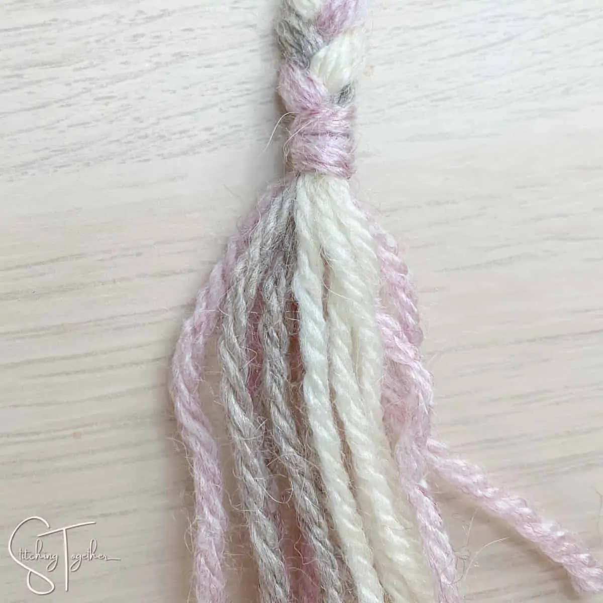 securing the braid with yarn