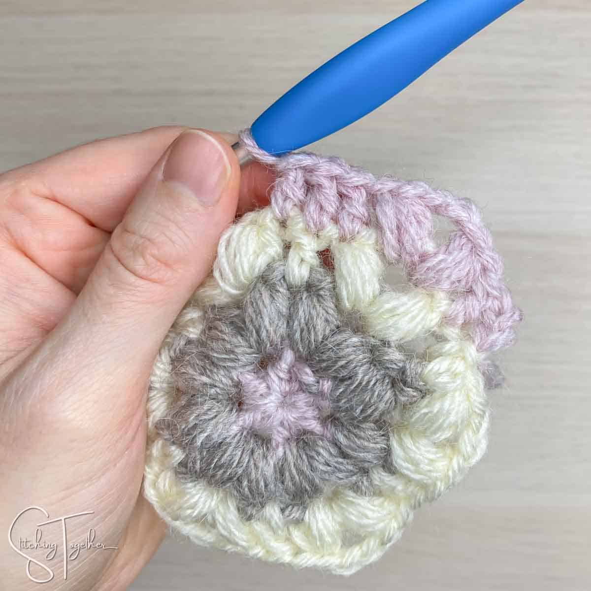 showing stitch placement for round 4 of a hexagon