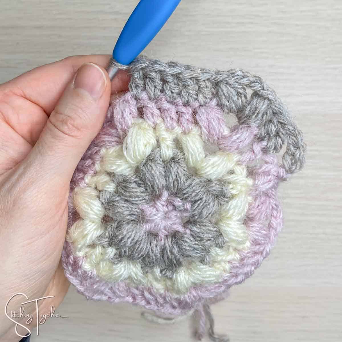 showing stitch placement for round 5 of a crochet hexagon