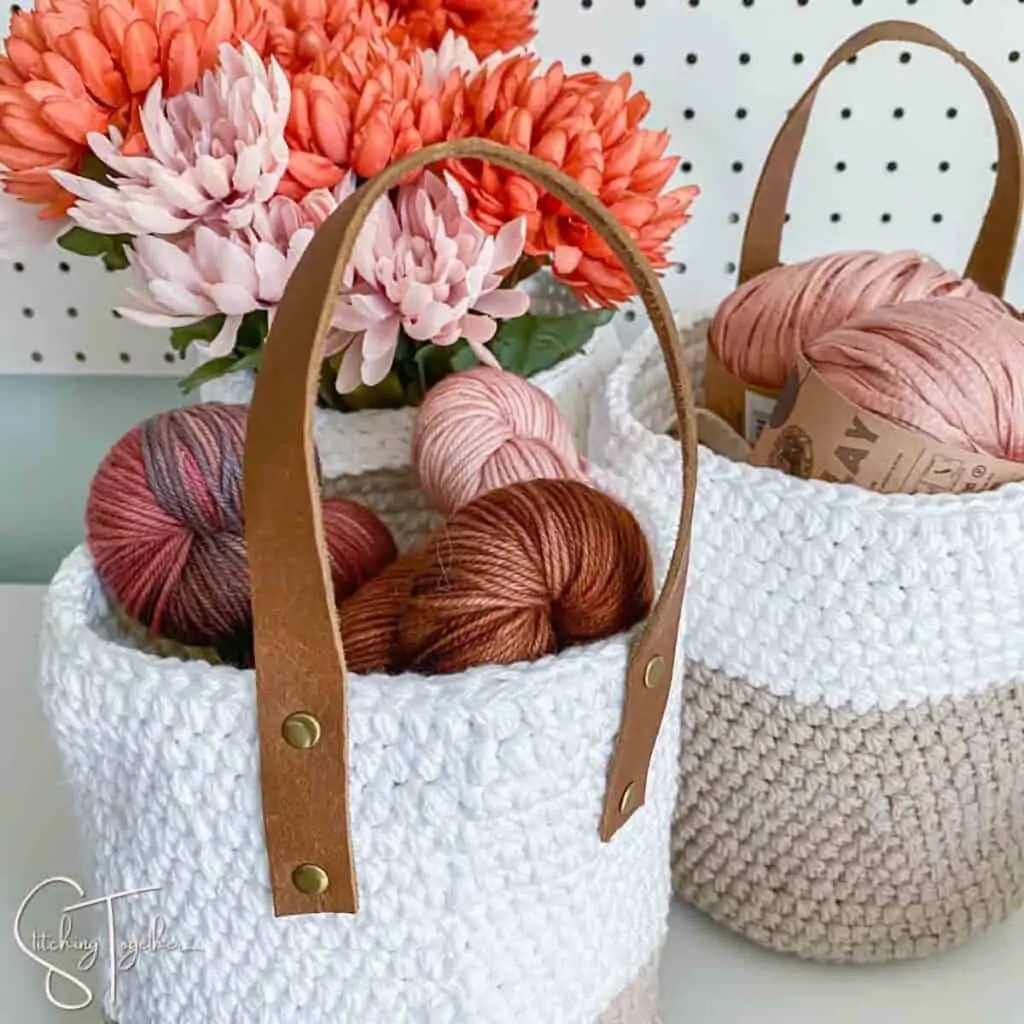 backside of a hanging crochet basket showing the leather strap