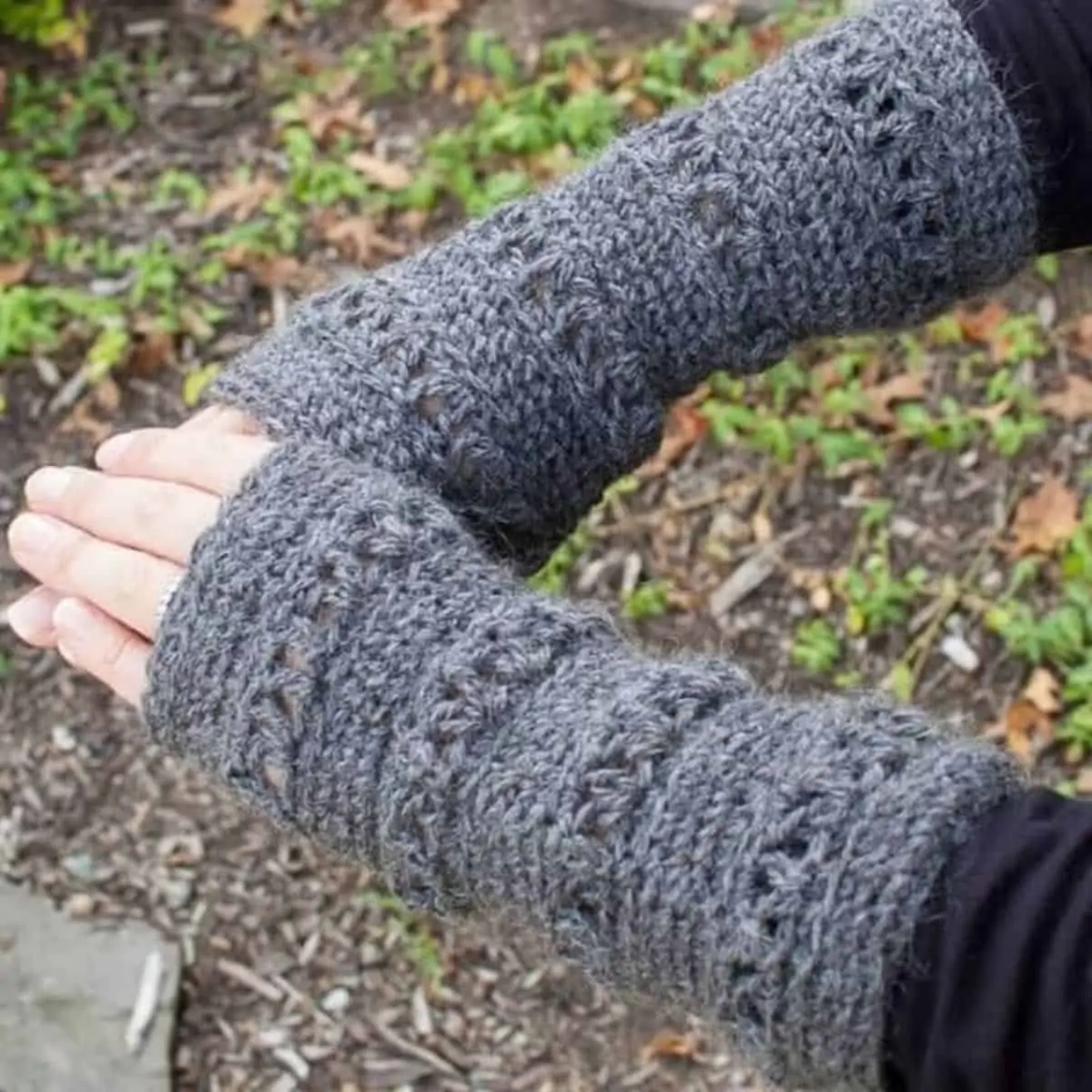 gray crochet wrist warmers being worn