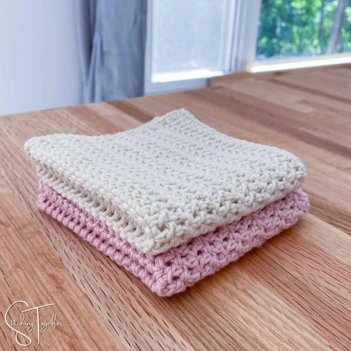 stack of two crochet dishcloths folded on a counter