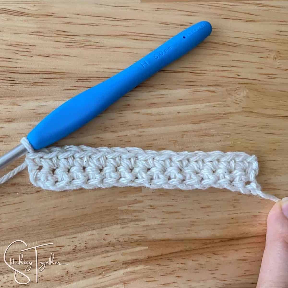 completed row of single crochet and hook