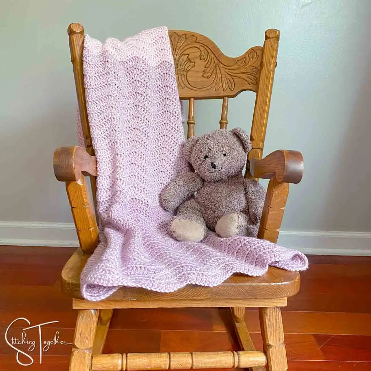 baby blanket ripple crochet draped over a small rocking chair