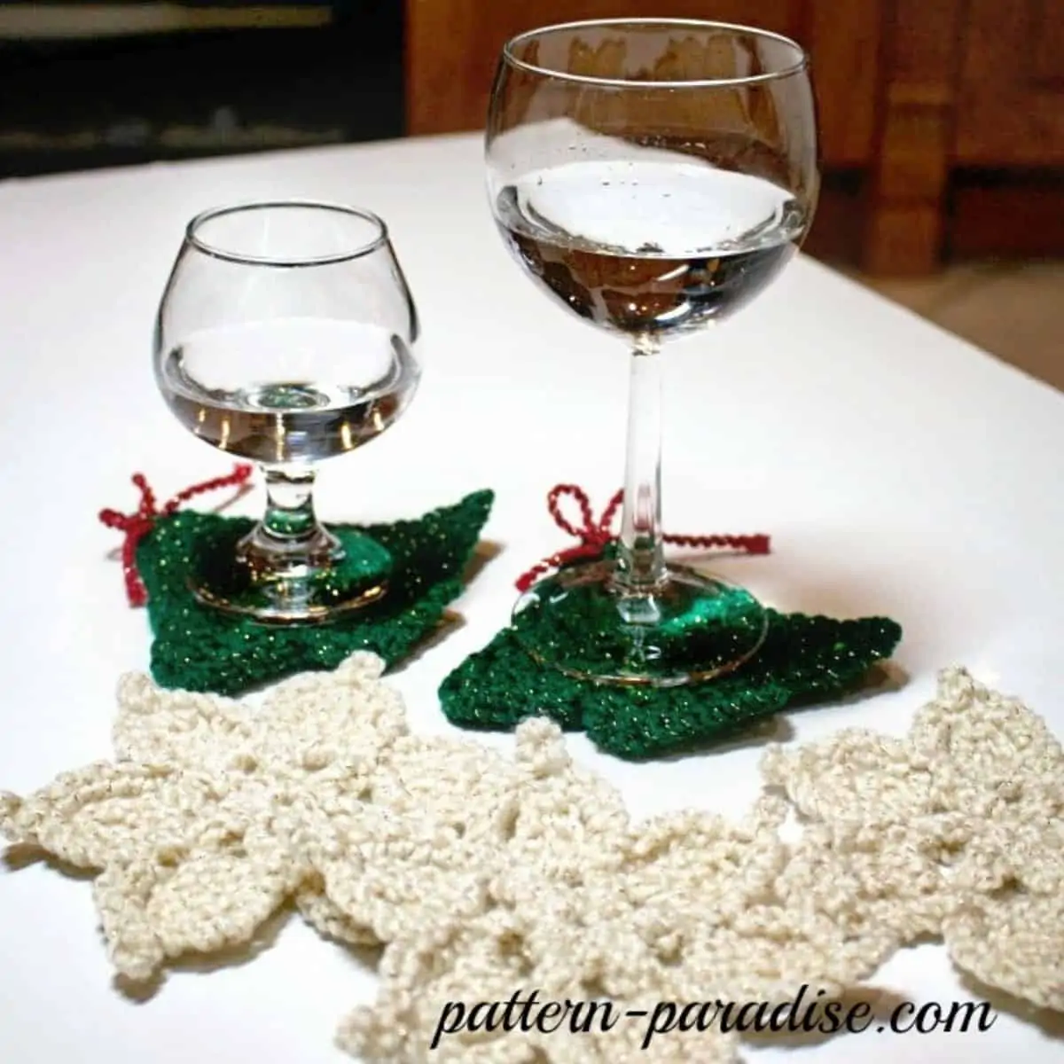 tree and snowflake crochet coasters with wine glasses