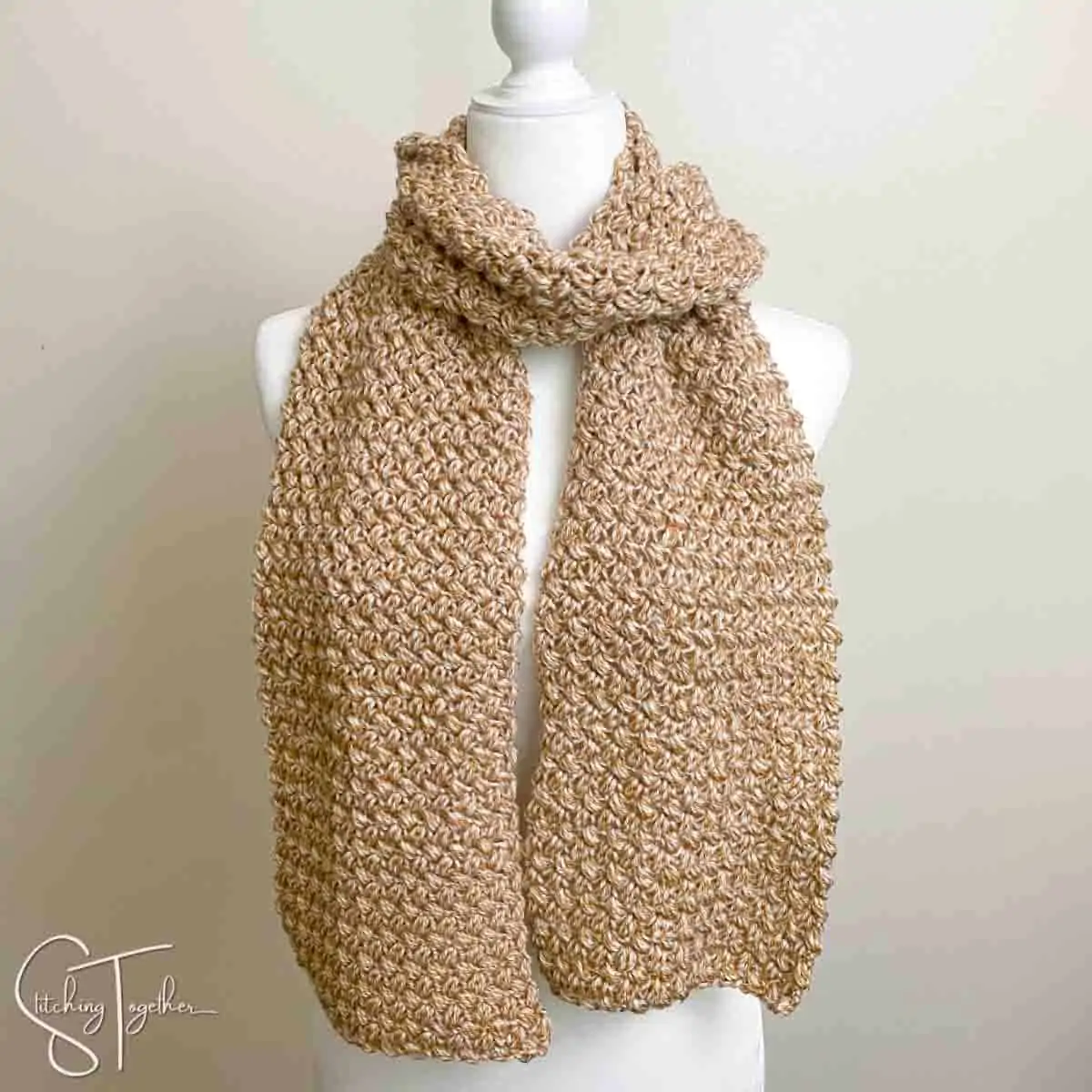 bean stitch crochet scarf wrapped around mannequin