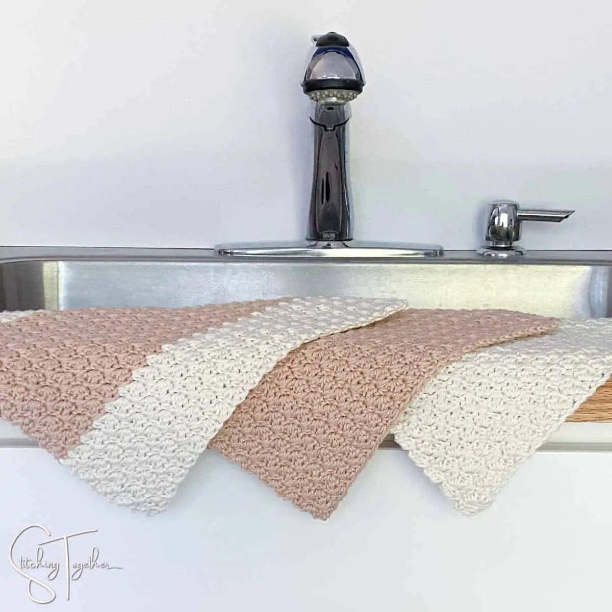 3 crochet dishcloths draped over the side of a sink