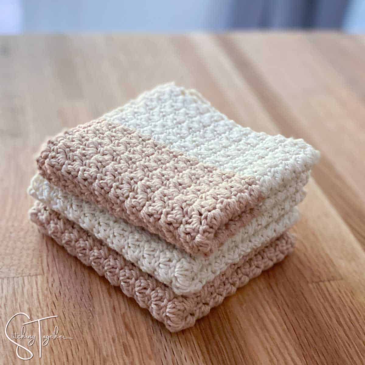 3 crochet dishcloths folded on a counter