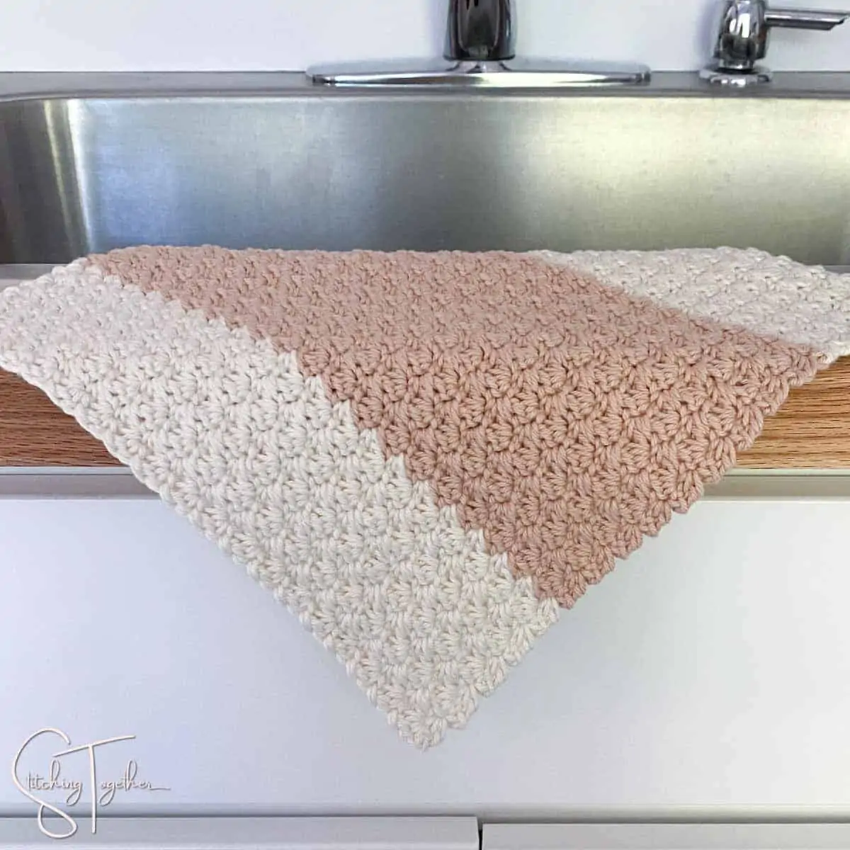 one crochet dishcloth suzette stitch draped on the side of a sink