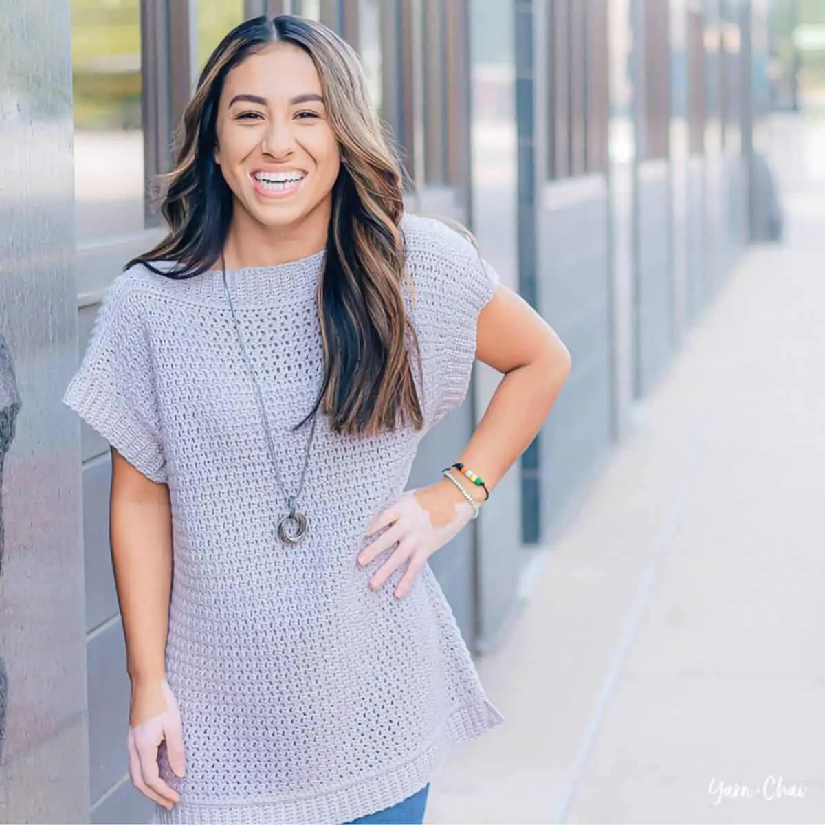 woman wearing a gray crochet top