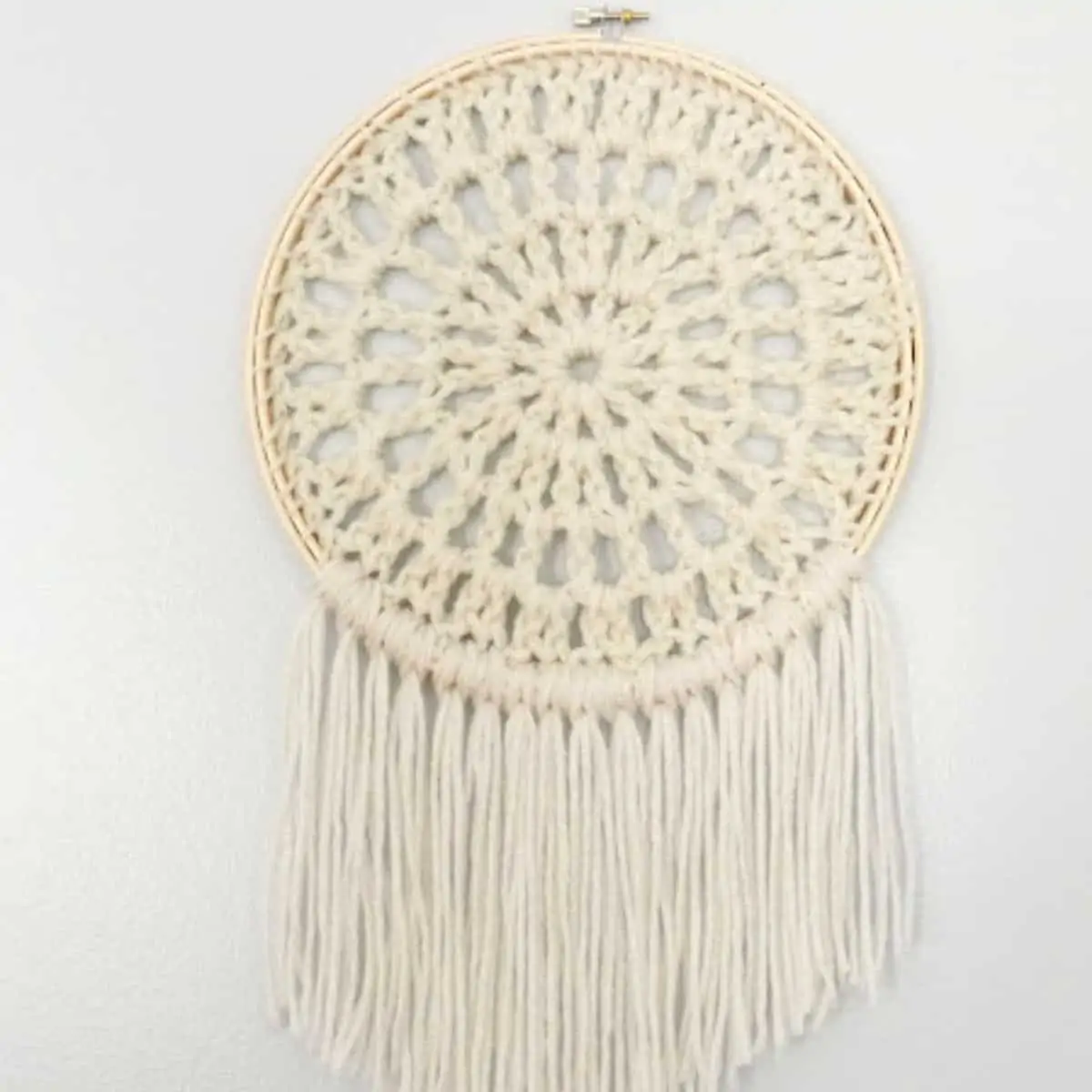round crochet wall hanging in an embroidery hoop
