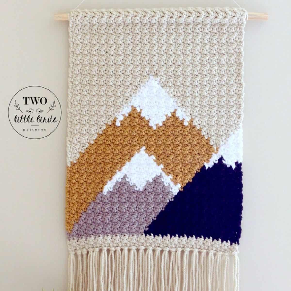 crochet wall tapestry with 3 mountain peeks covered in snow
