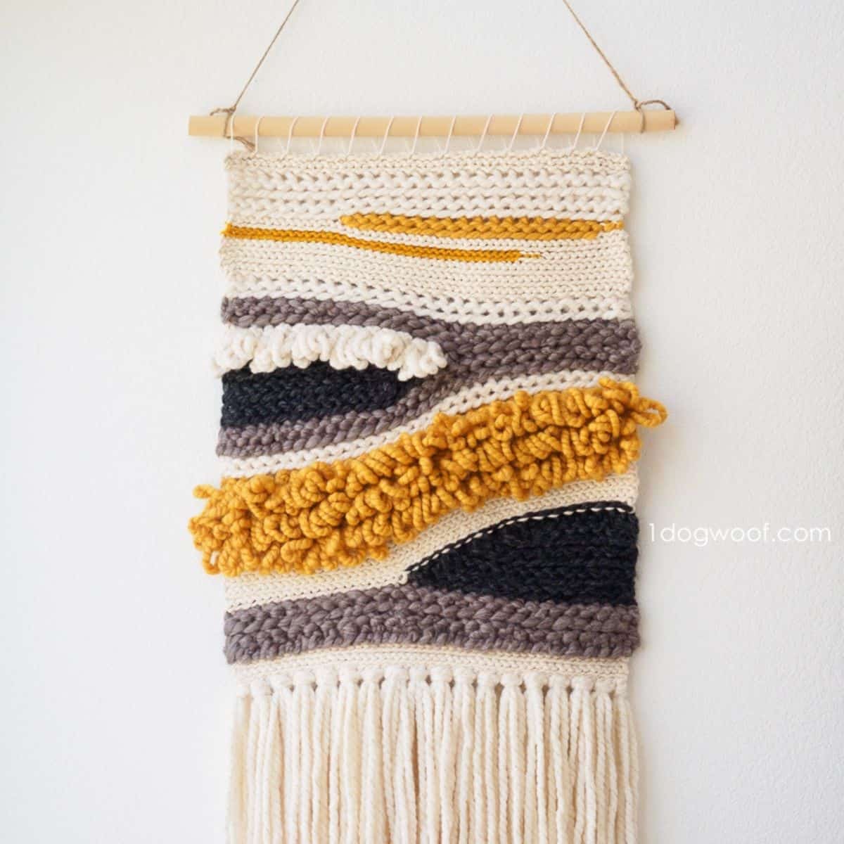 gold, ivory, black, and gray textured crochet wall hanging