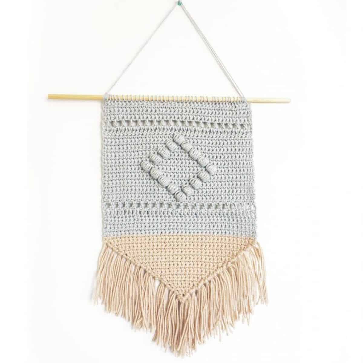 2 toned wall hanging with a diamond puff center and fringe