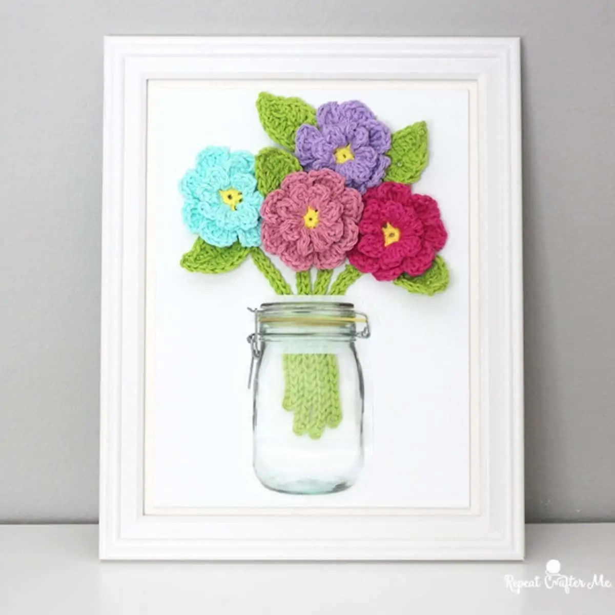 a mason jar sticker with crochet flowers inside a frame
