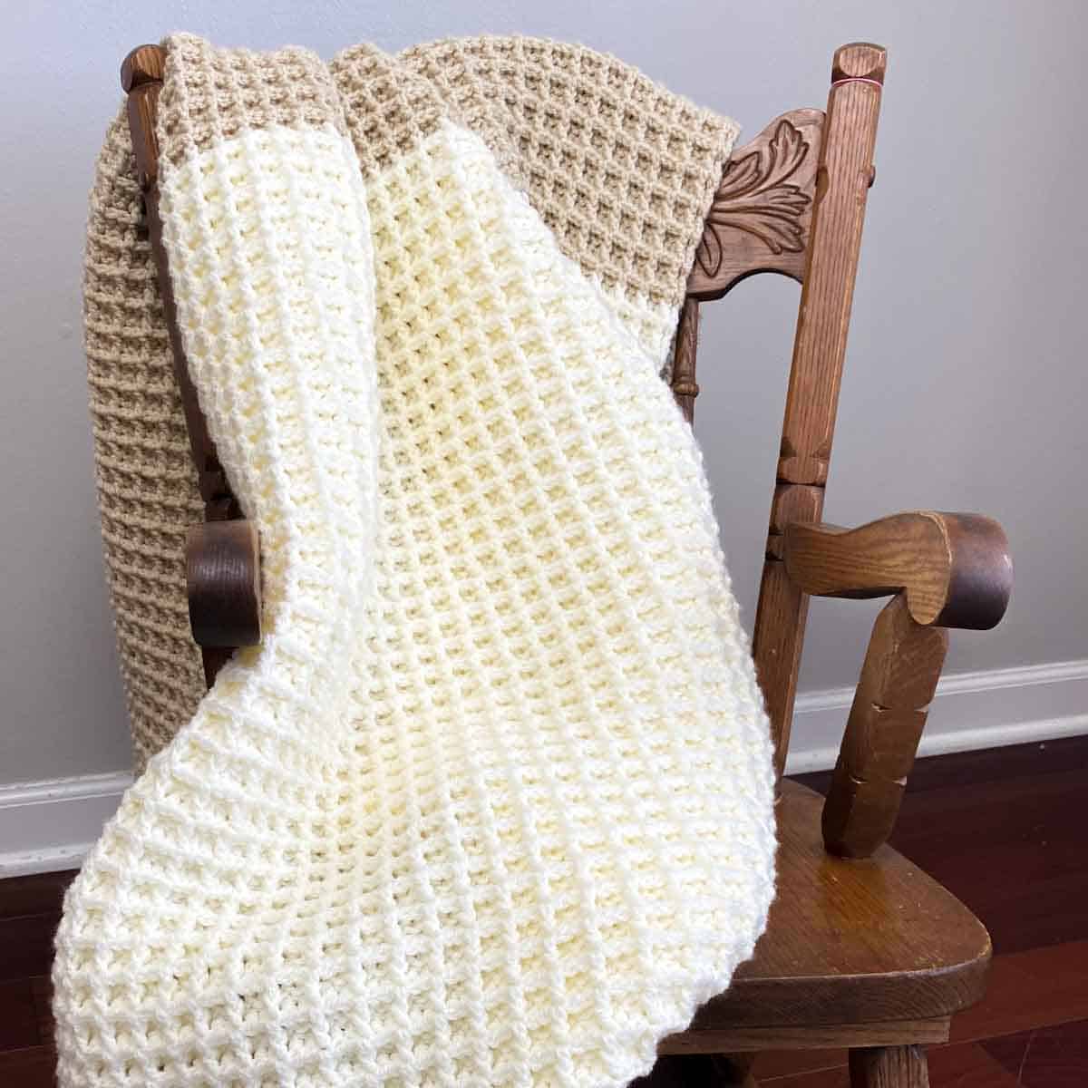crochet waffle stitch blanket draped over a small rocking chair