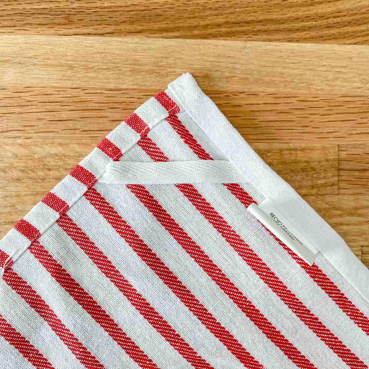 backside of a red and white striped dishtowel showing the hanging loop