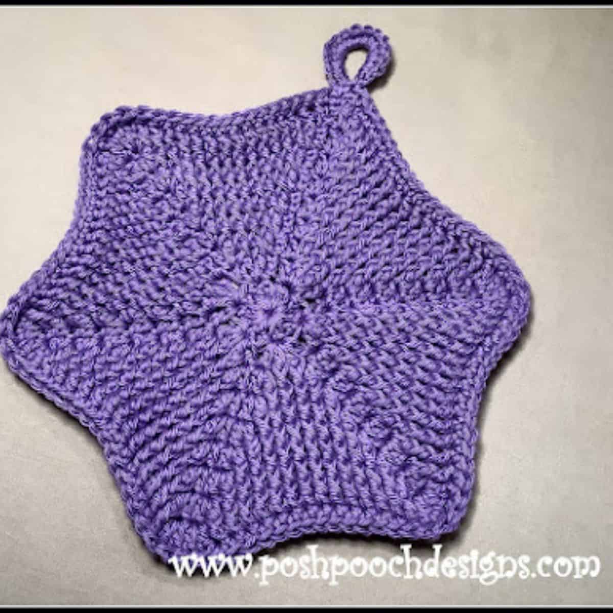 purple hexagon crochet potholder laying flat